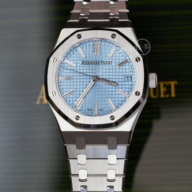 Audemars Piguet Royal Oak Ice Blue Dial with Baguette Diamond Hour Markers - Shown against the official Audemars Piguet green lacquered wood box.